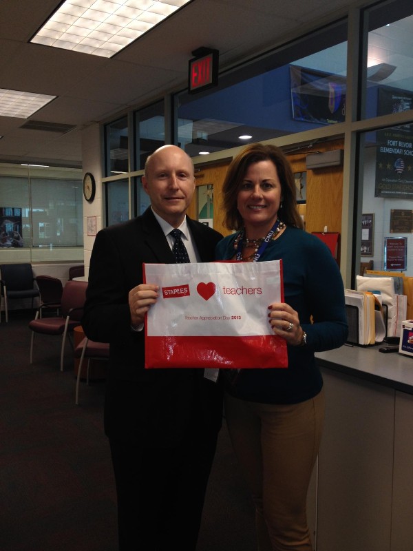 Bill Jones, chapter president, presents Nancy Rowland, STEM coordinator at Fort Belvoir Elementary School, with 100 $50 gift cards for teachers at the school in October.